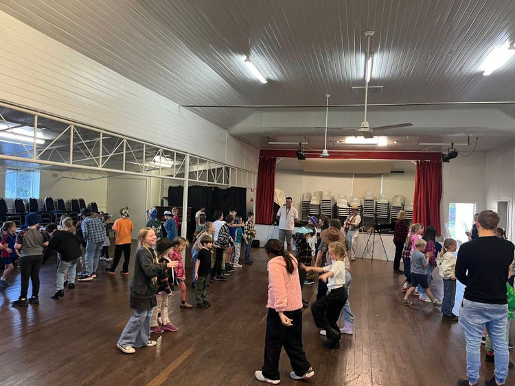 Students learning a bush dance in the Bonville hall