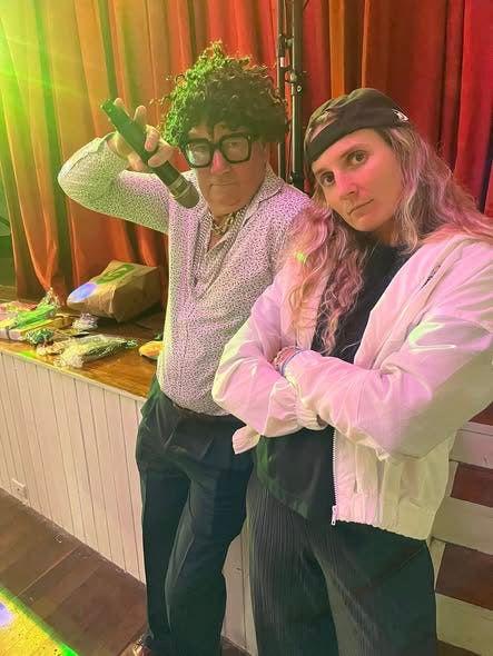 Two Bonville staff dressed in disco style outfits for the school disco