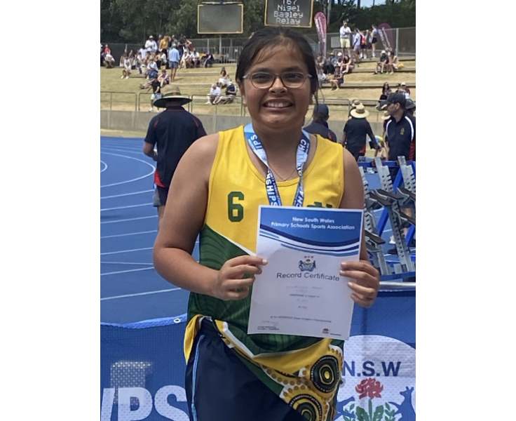 A year five Bonville student displaying her silver medal for discus at the State Athletics Carnival