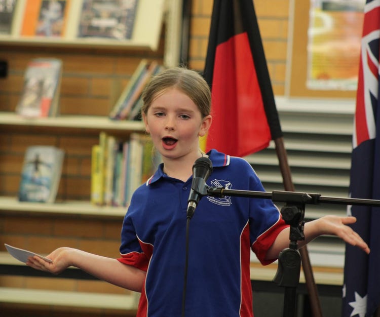 A year two student using hand gestures and an expressive face to make a point during public speaking