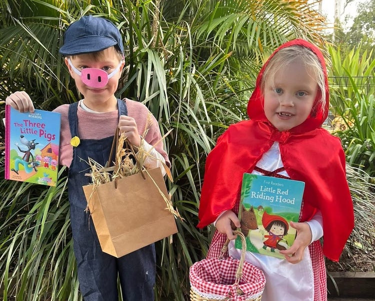 Two students dressed in costume for book week - one as Little Red Riding Hood and the other as one of the three little pigs